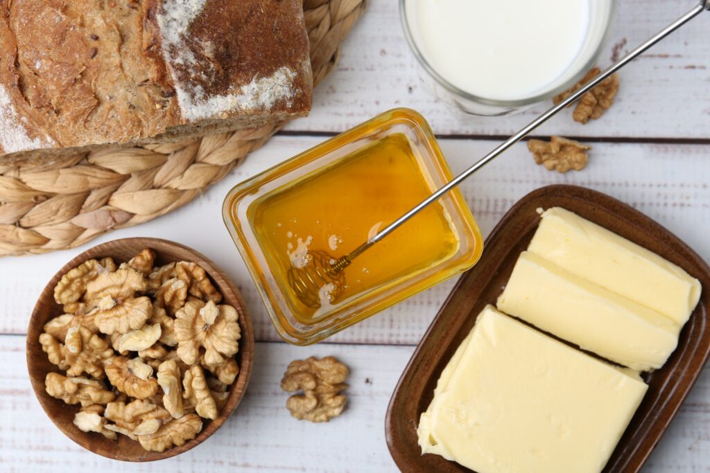 Sweet,Honey,,Butter,,Milk,,Bread,And,Walnuts,On,White,Wooden