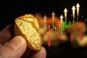 Male,Hand,Holding,Gold,Ingot,And,Fluctuating,Gold,Price,Chart